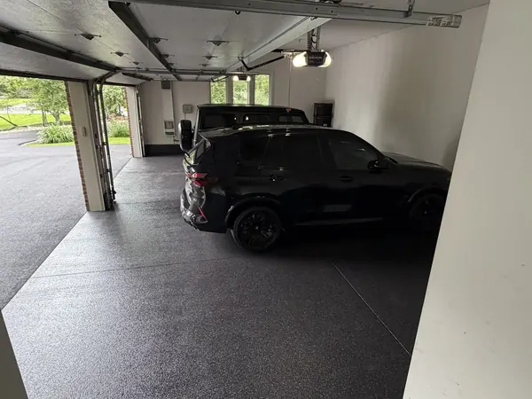 Black SUV on a flake garage floor