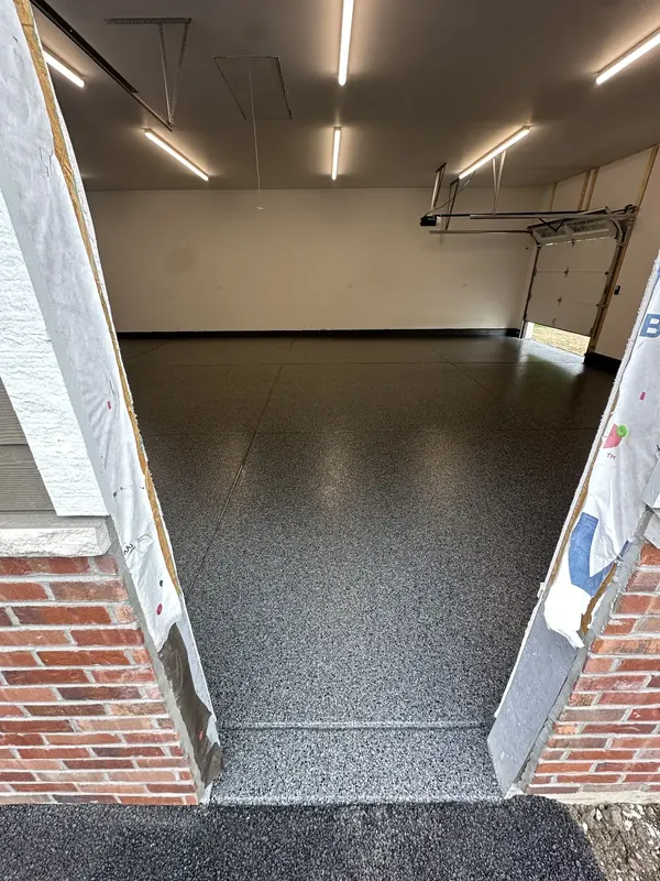 View into a garage through a brick entry