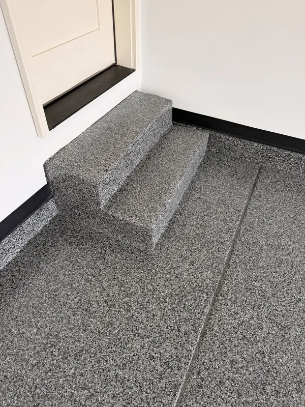 Coated entry steps in a corner
