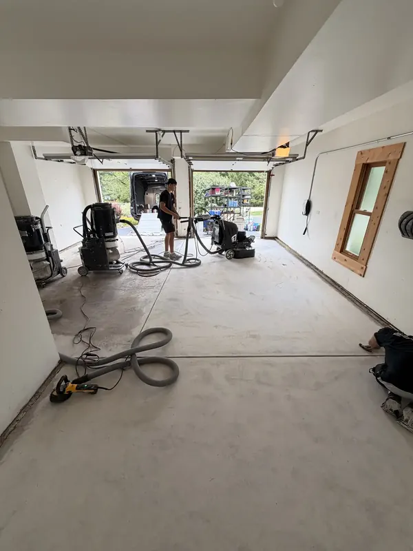 Crew grinding garage concrete