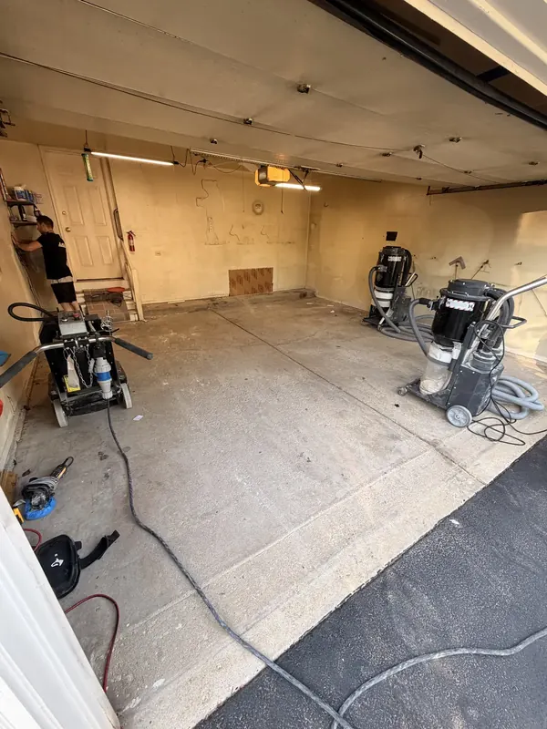 Grinder and dust vacuums set up on a floor