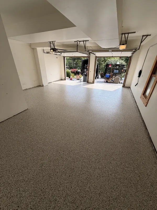 Finished floor in a long garage with two doors