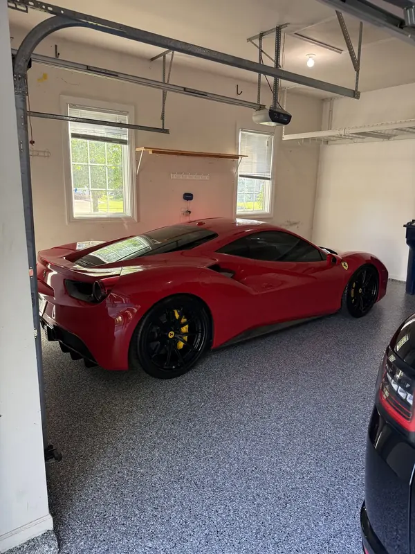 Red sports car in a coated garage