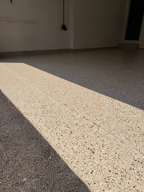 Sunlit beige flake garage floor