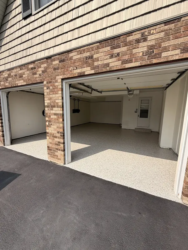 Speckled floor seen from outside a two car garage