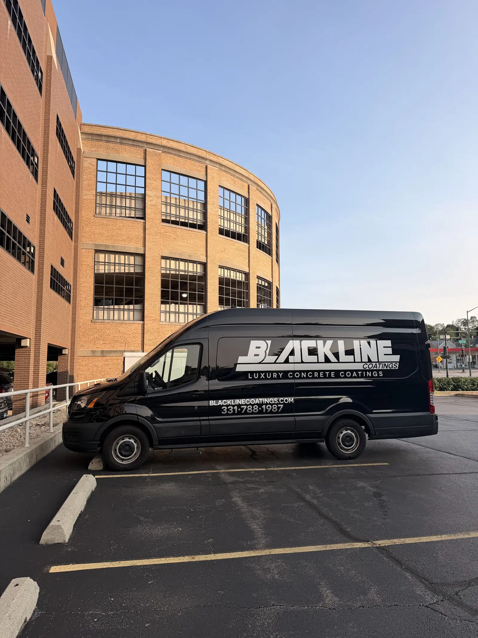 The blacked out Blackline Coatings van with its chrome wordmark