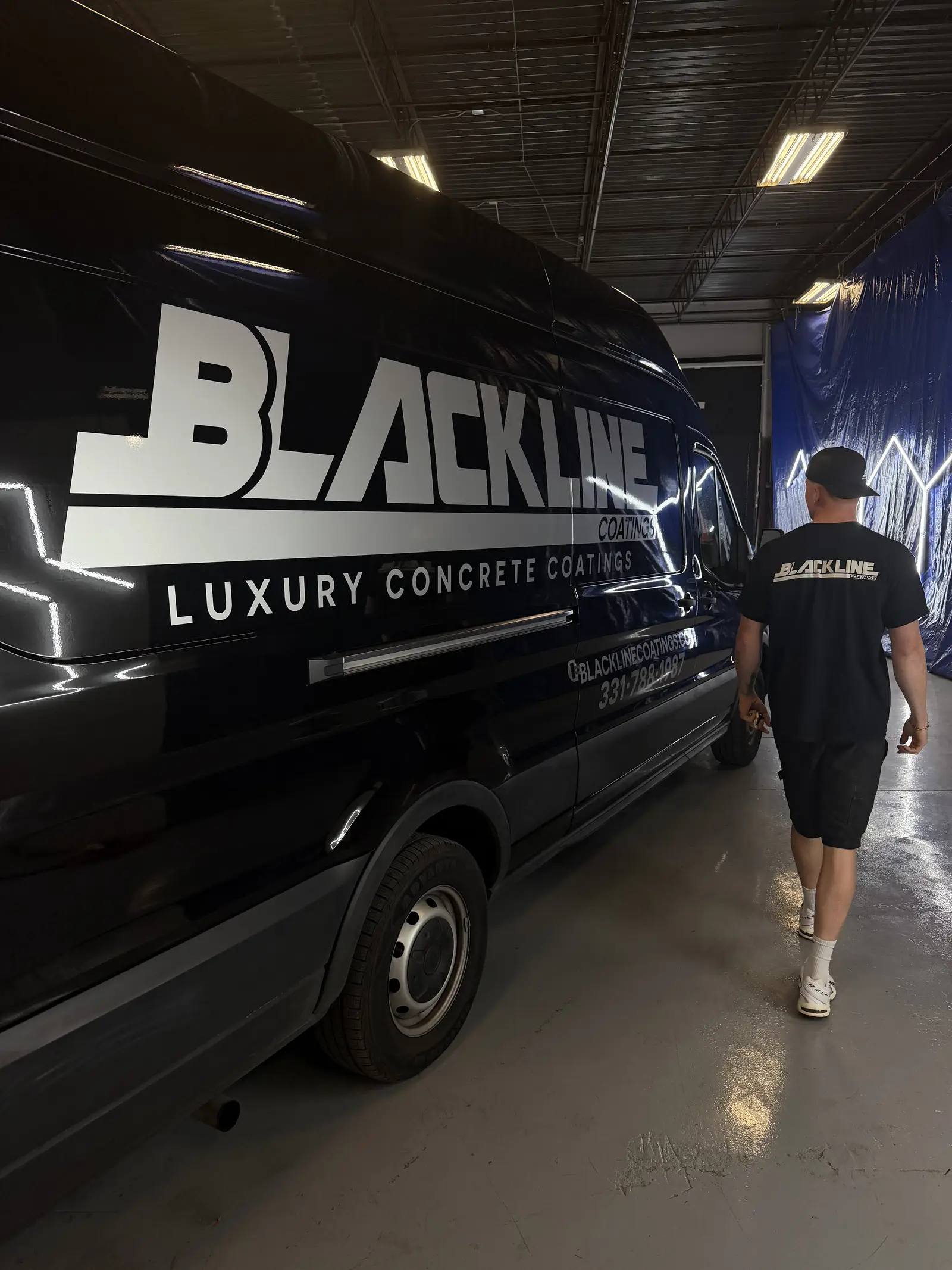 Judah Reynolds walking to the Blackline Coatings van, chrome wordmark on blacked out bodywork