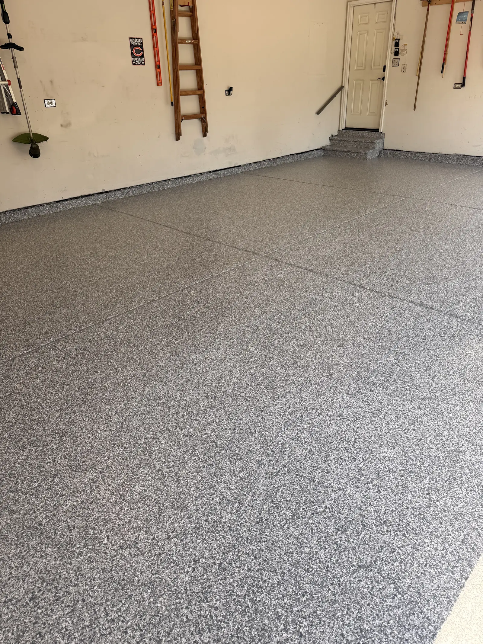 Charcoal flake coated garage floor photographed wide from the doorway