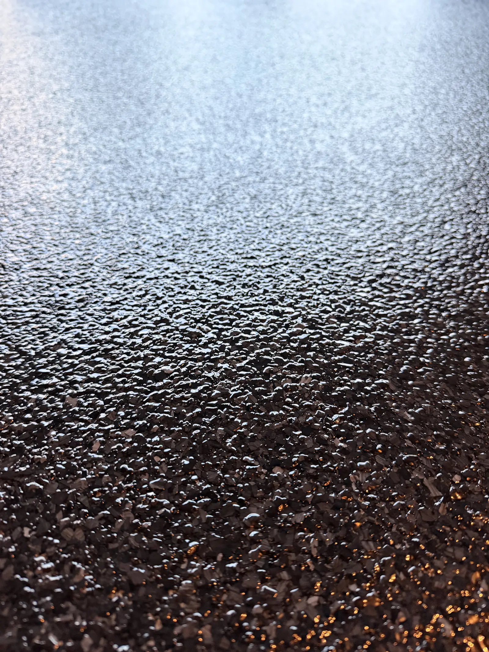 Close detail of a copper and black flake floor finish