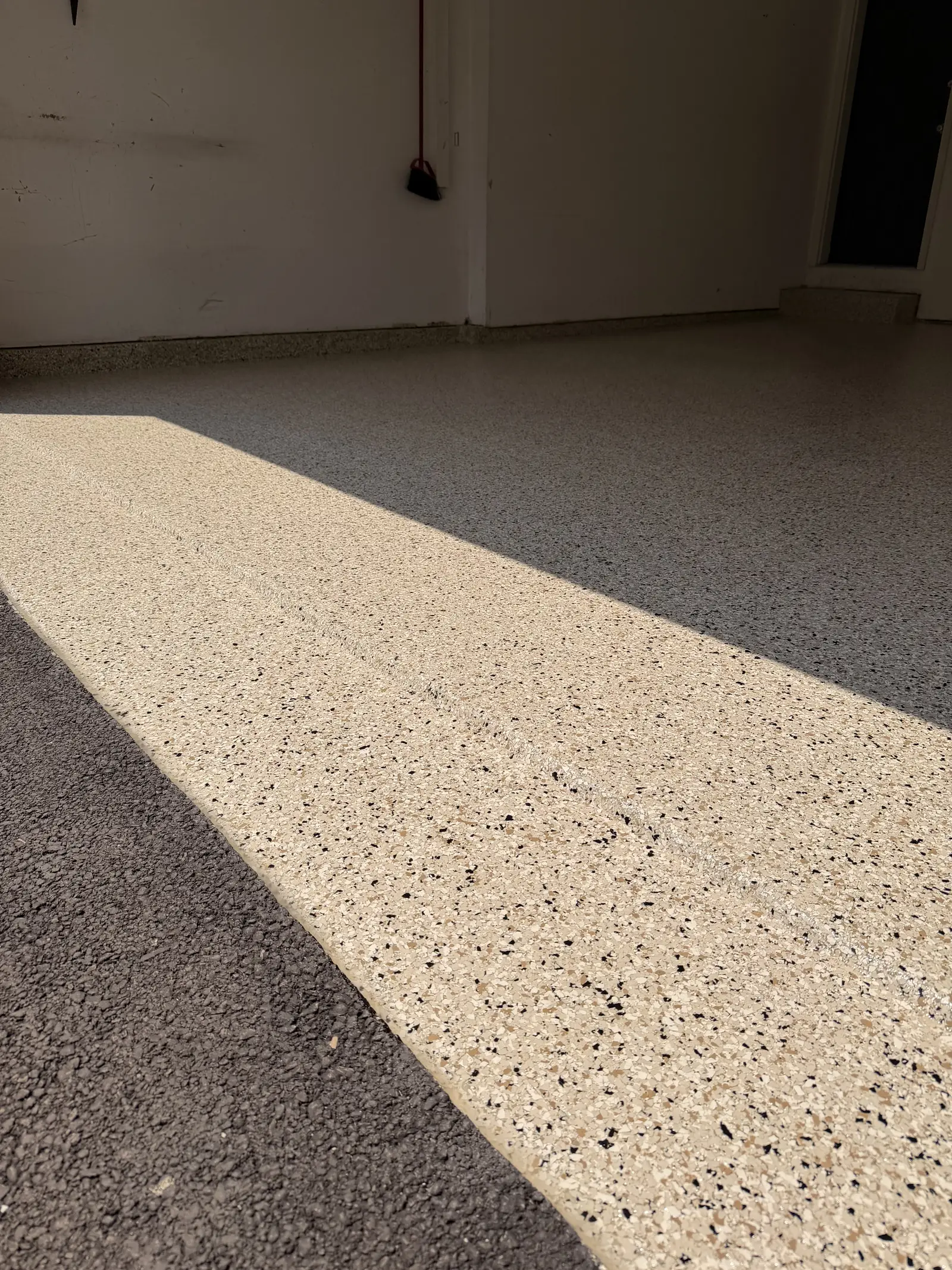 Cream and grey flake coated garage floor in sunlight
