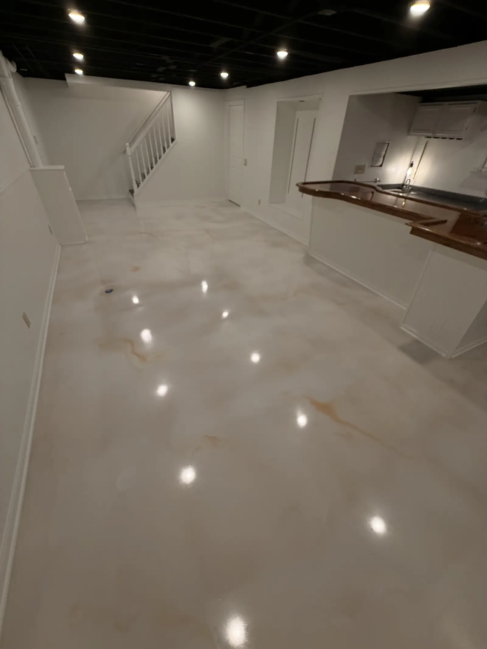 Pearl marble metallic floor running the length of a finished open room